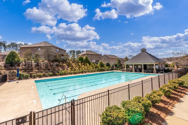 community pool featuring a patio area and fence