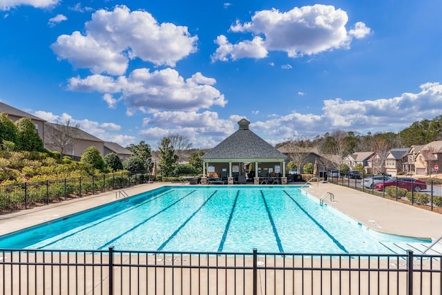 pool featuring a gazebo, a patio, and fence