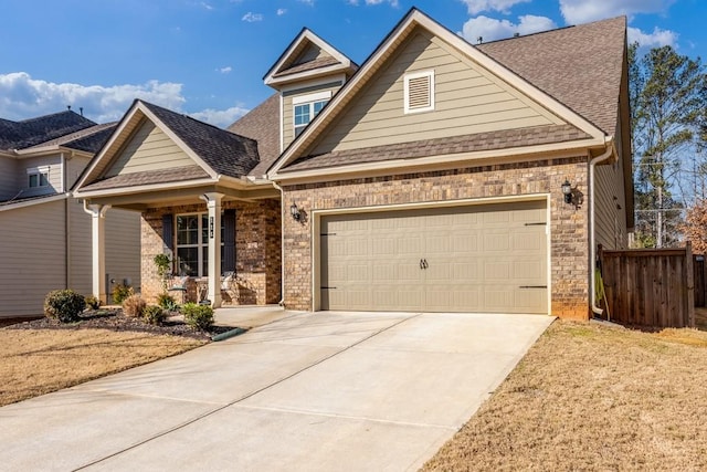 view of front of property with driveway, a shingled roof, an attached garage, fence, and brick siding