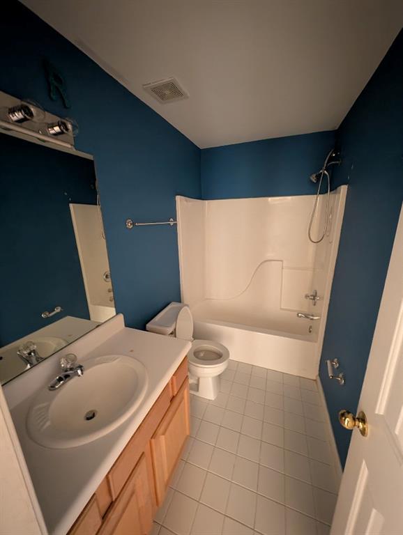 3967 Moos Creek Ct, Loganville, GA 30052 - full bathroom with shower / washtub combination, vanity, visible vents, toilet, and tile patterned floors