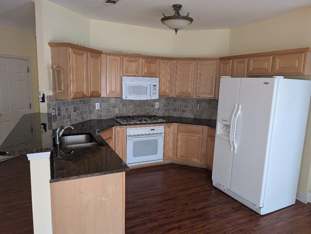 3967 Moos Creek Ct, Loganville, GA 30052 - kitchen with a sink, white appliances, dark stone countertops, and dark wood-type flooring
