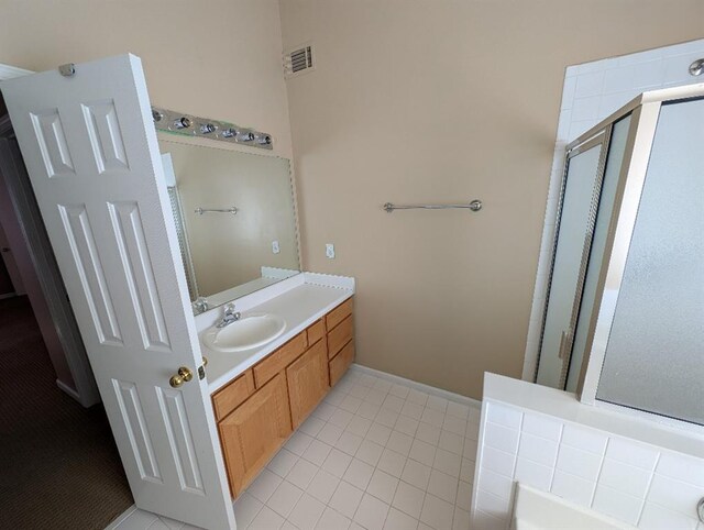 3967 Moos Creek Ct, Loganville, GA 30052 - full bathroom with visible vents, vanity, a stall shower, and tile patterned flooring