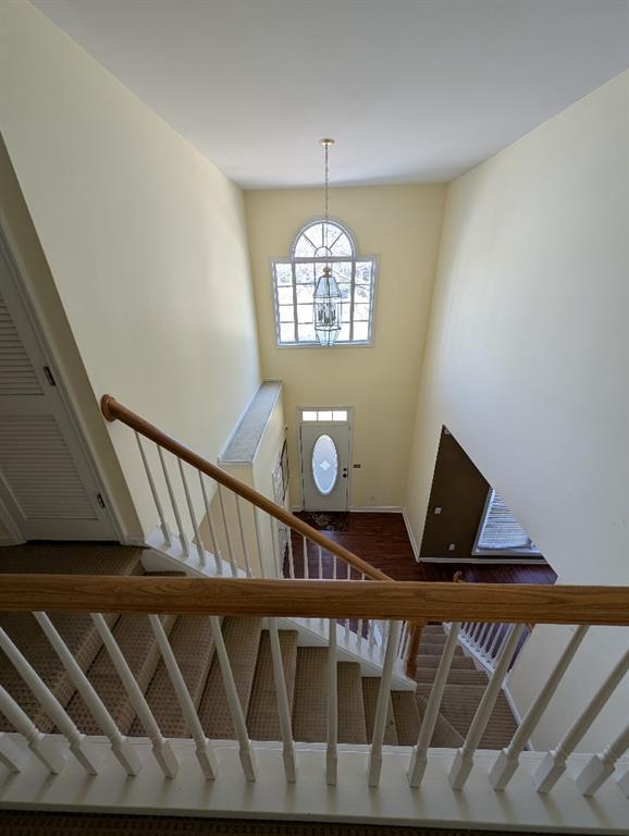 3967 Moos Creek Ct, Loganville, GA 30052 - stairs featuring baseboards and a notable chandelier