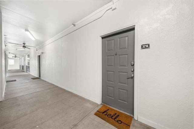 doorway to property featuring ceiling fan