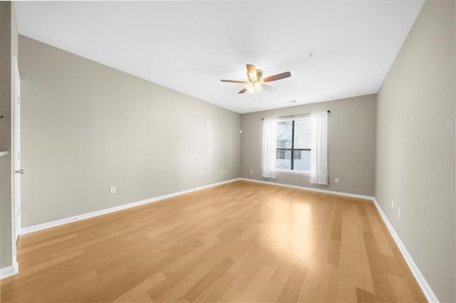 spare room featuring ceiling fan and light wood-type flooring