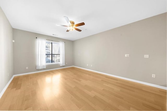 spare room featuring ceiling fan and light wood-type flooring