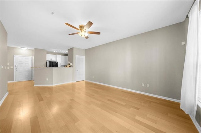 unfurnished living room with light hardwood / wood-style flooring and ceiling fan