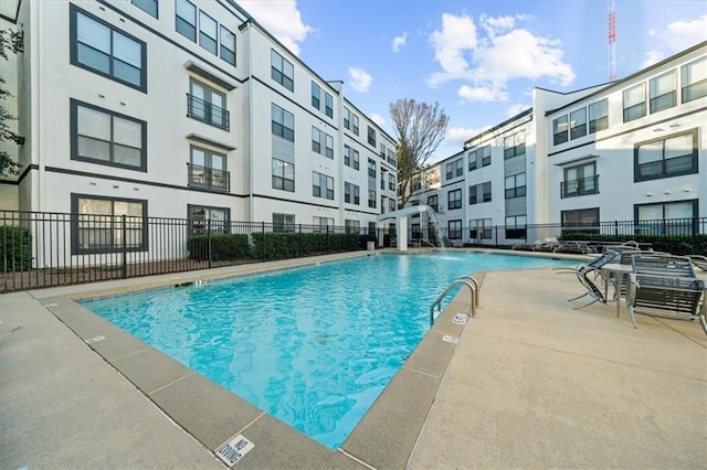 view of pool featuring pool water feature and a patio area