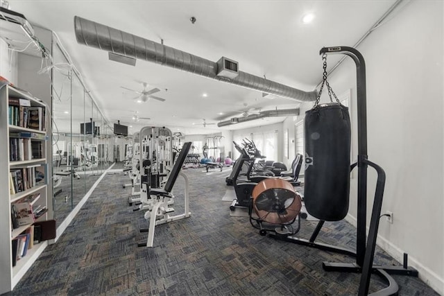 exercise room featuring ceiling fan and carpet