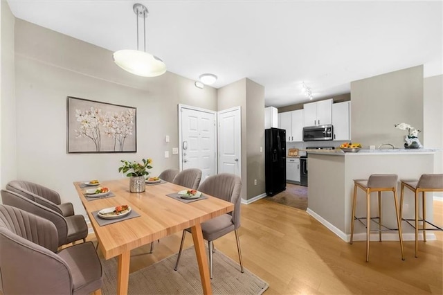 dining area with light hardwood / wood-style floors