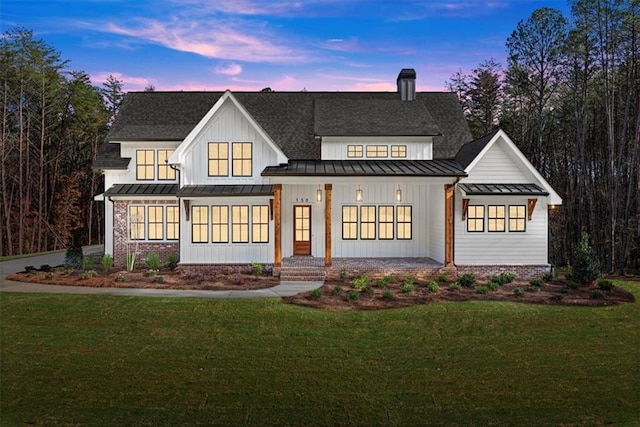 view of front of property with a porch and a yard