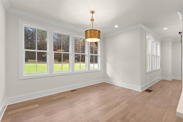 unfurnished dining area with a wealth of natural light and light hardwood / wood-style floors