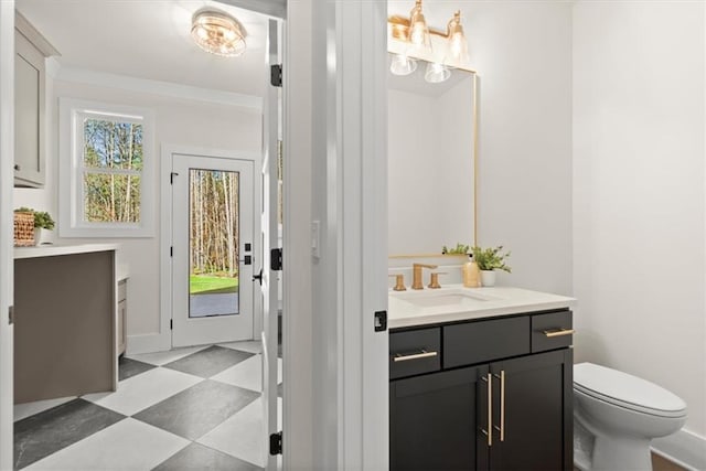 bathroom featuring vanity, toilet, and an inviting chandelier