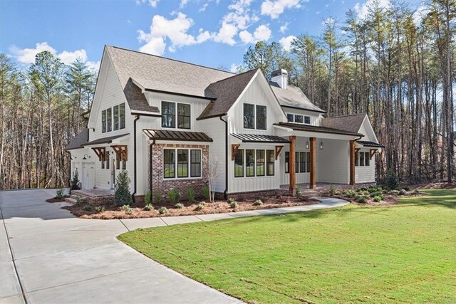 modern farmhouse with a porch and a front yard