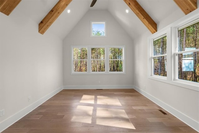 additional living space with beam ceiling, light wood-type flooring, and high vaulted ceiling