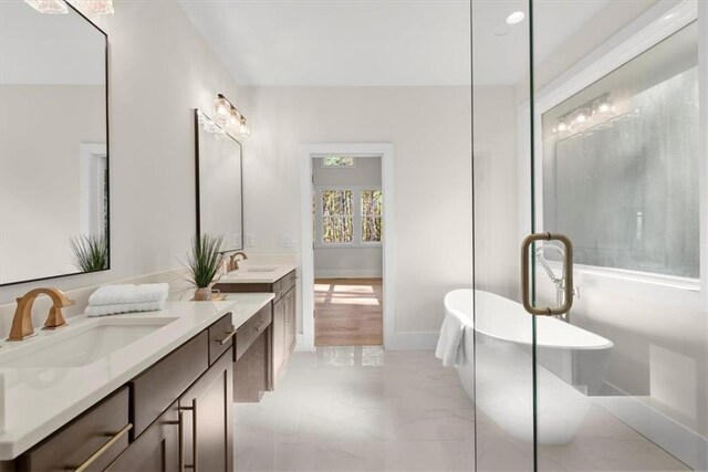 bathroom featuring a bath and vanity