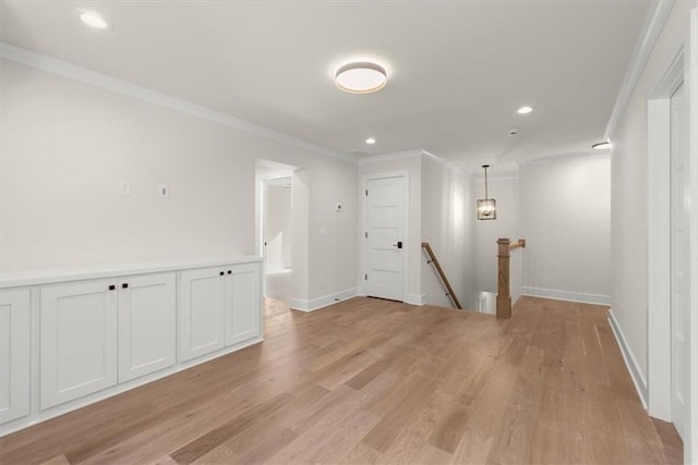 interior space with light hardwood / wood-style floors and crown molding