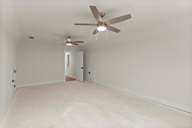 carpeted empty room with ceiling fan and lofted ceiling