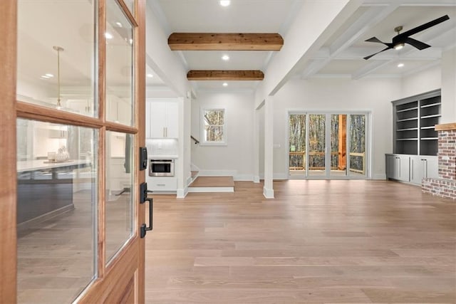 interior space featuring beam ceiling, light hardwood / wood-style flooring, and ceiling fan