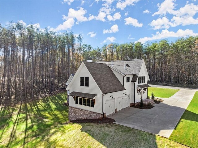 view of home's exterior featuring a yard and a garage