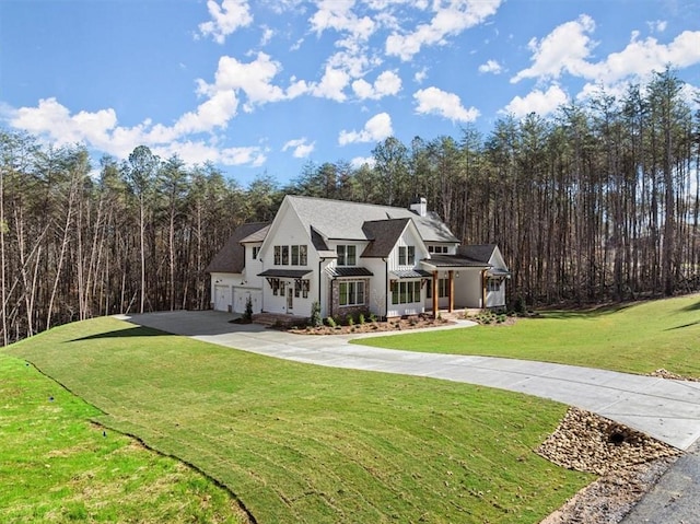 view of front of home featuring a garage and a front lawn