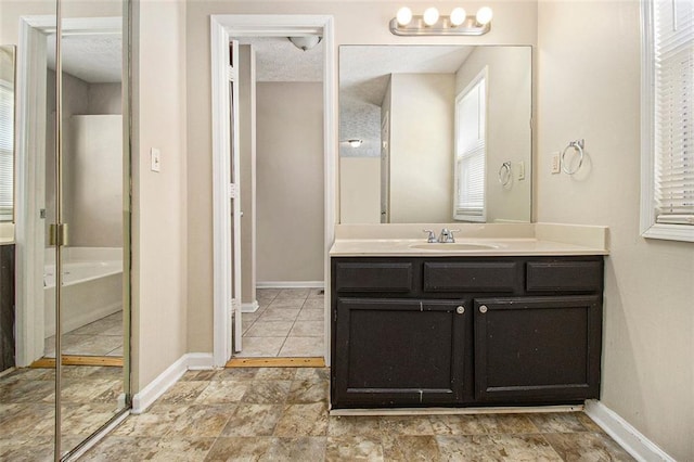 bathroom featuring vanity and independent shower and bath