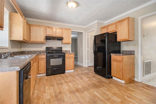 kitchen featuring a textured ceiling, black appliances, sink, light wood-type flooring, and crown molding