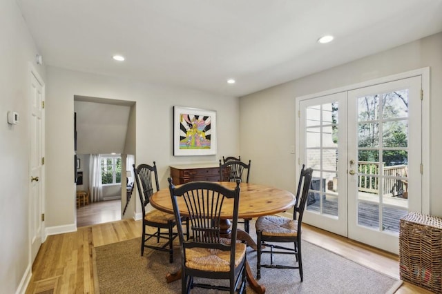 dining area with french doors and light wood-type flooring