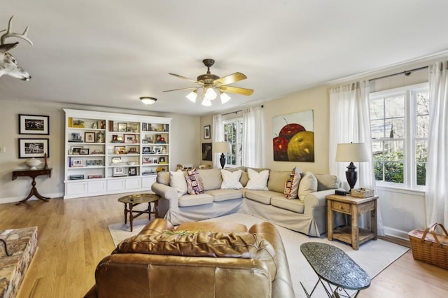 living room with ceiling fan and light hardwood / wood-style flooring