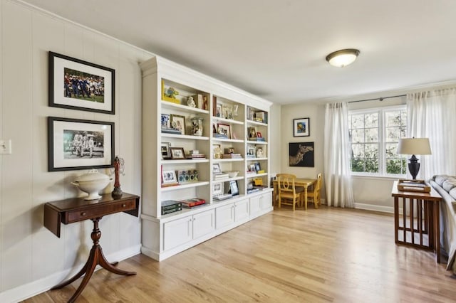 sitting room with light hardwood / wood-style flooring and built in features