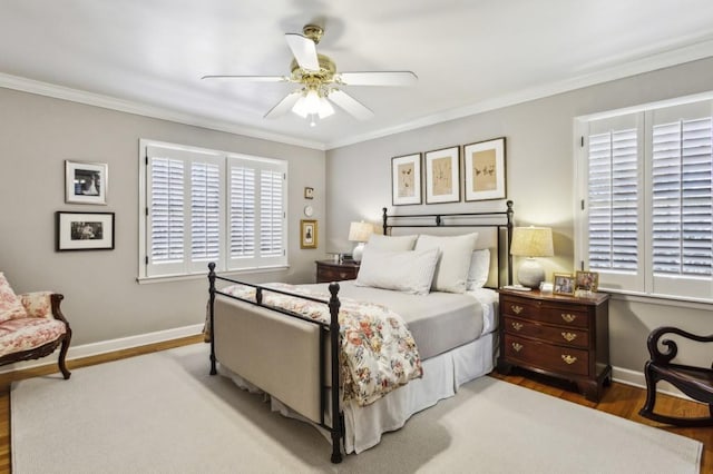 bedroom featuring ceiling fan, wood-type flooring, and ornamental molding