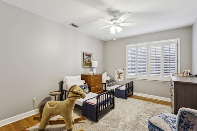 bedroom with light hardwood / wood-style flooring and ceiling fan