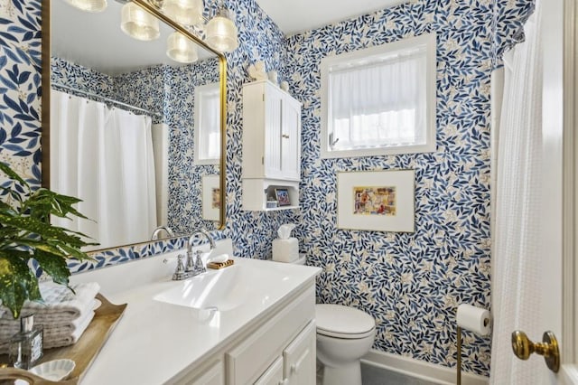 bathroom featuring an inviting chandelier, vanity, and toilet