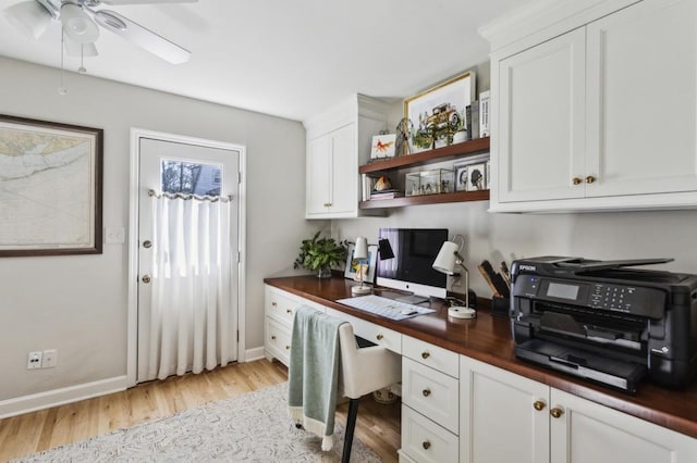 office with ceiling fan, built in desk, and light hardwood / wood-style floors