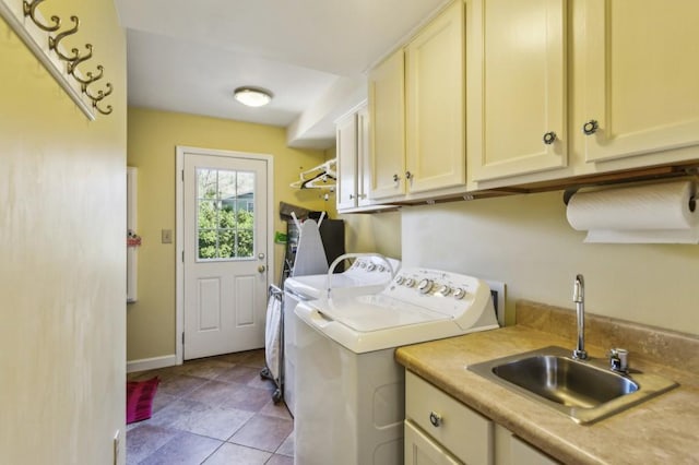 clothes washing area with cabinets, independent washer and dryer, and sink