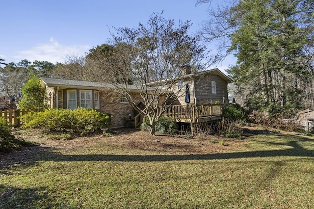 view of front facade featuring a front yard and a deck