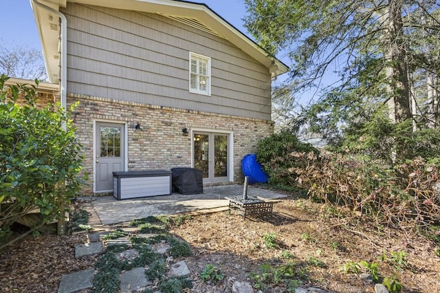 rear view of house featuring french doors and a patio area