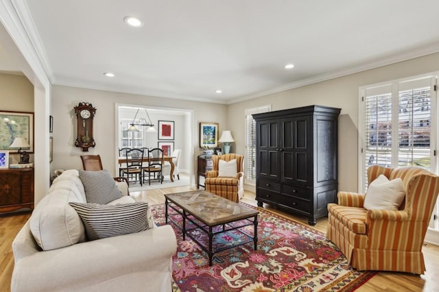 living room featuring light wood-type flooring and ornamental molding