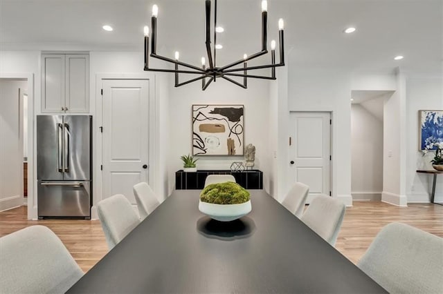 dining space featuring an inviting chandelier and light wood-type flooring