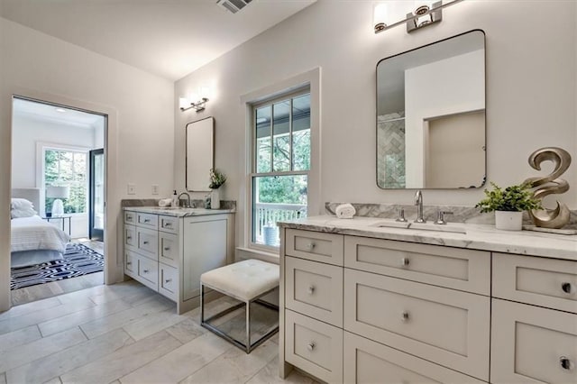 bathroom with hardwood / wood-style floors, vanity, and plenty of natural light