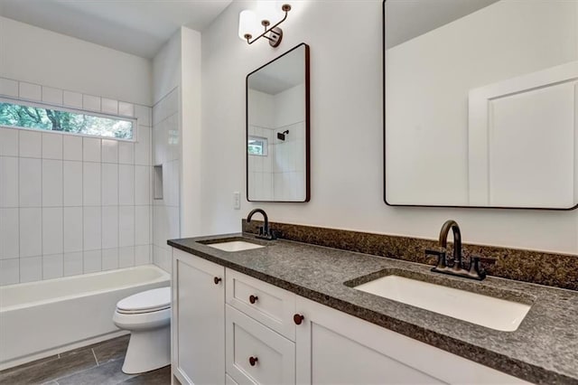 full bathroom with vanity, toilet, and tiled shower / bath combo