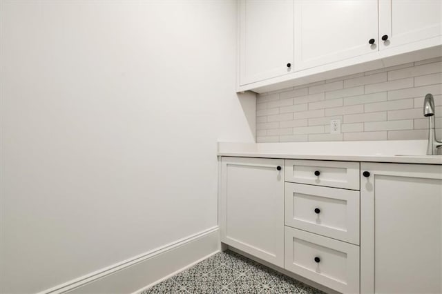 interior space with sink and tasteful backsplash