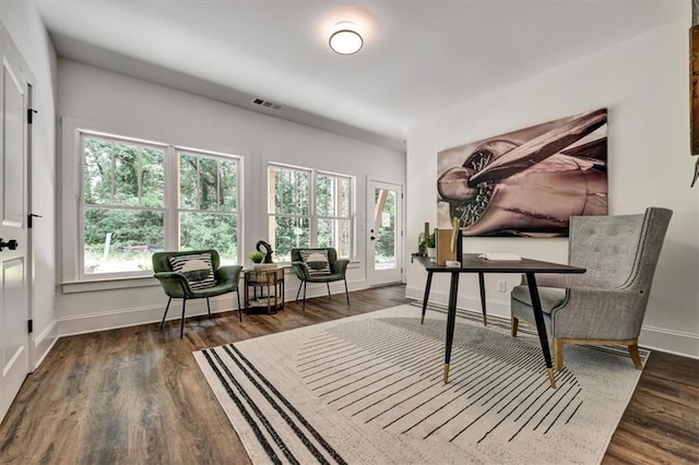 sitting room with dark wood-type flooring