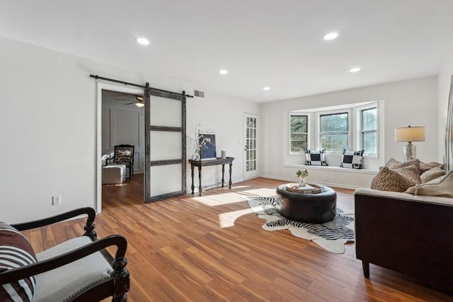 6851 Roswell Rd Unit N-20, Sandy Springs, GA 30328 - living room featuring a barn door, wood finished floors, recessed lighting, and baseboards
