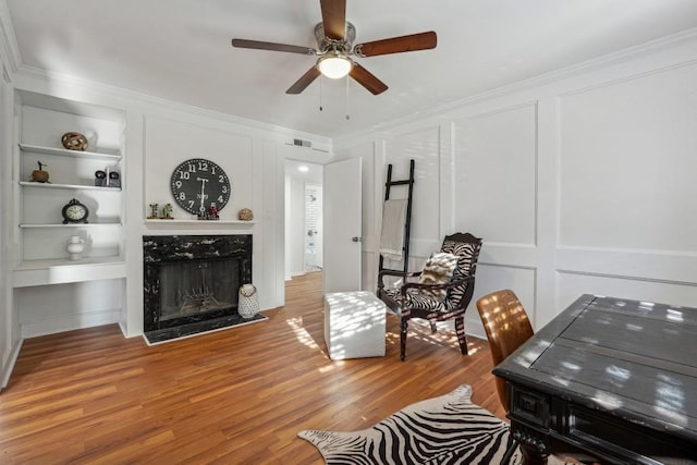 6851 Roswell Rd Unit N-20, Sandy Springs, GA 30328 - living area with a decorative wall, built in features, a ceiling fan, light wood-style floors, and a fireplace