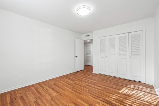 6851 Roswell Rd Unit N-20, Sandy Springs, GA 30328 - unfurnished bedroom featuring light wood-style floors, baseboards, and a closet