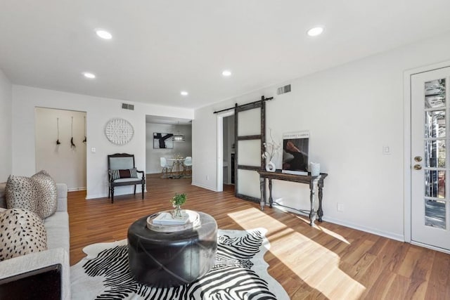 6851 Roswell Rd Unit N-20, Sandy Springs, GA 30328 - living area with a barn door, wood finished floors, recessed lighting, and baseboards