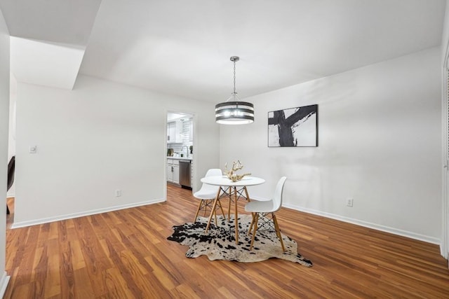 6851 Roswell Rd Unit N-20, Sandy Springs, GA 30328 - dining space featuring baseboards, wood finished floors, and a chandelier