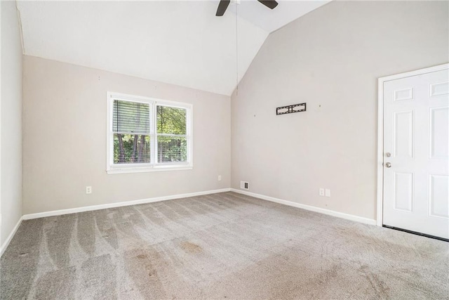 empty room with high vaulted ceiling, ceiling fan, and carpet floors