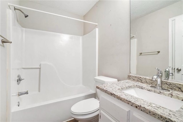 full bathroom featuring a textured ceiling, vanity, toilet, and tub / shower combination